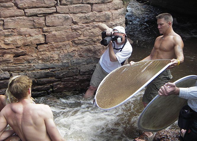 Brody Hall photographing two models in Colorado stream