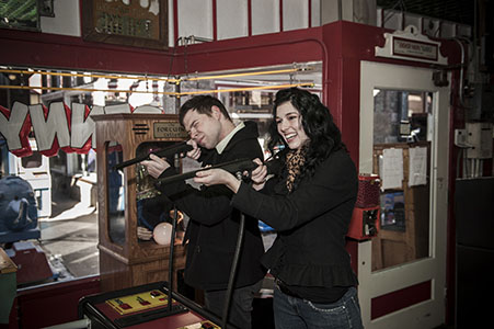 Engaged couple playing a game in the Penny Arcade in Manitou Springs, CO