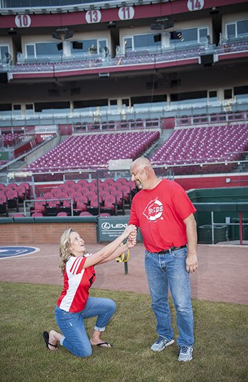MARRY ME Woman on her knee proposing to man on the field of the All American Ball Park in Cincinnati