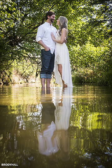 Engagment photo of couple standing in stream