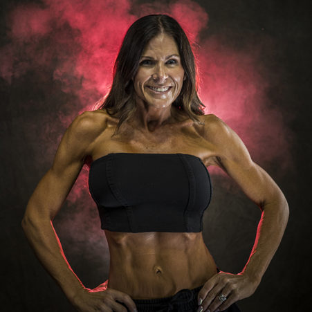 oiled up and slimmed down female fitness competitor taking some portrait photos before a competition in Nashville, TN